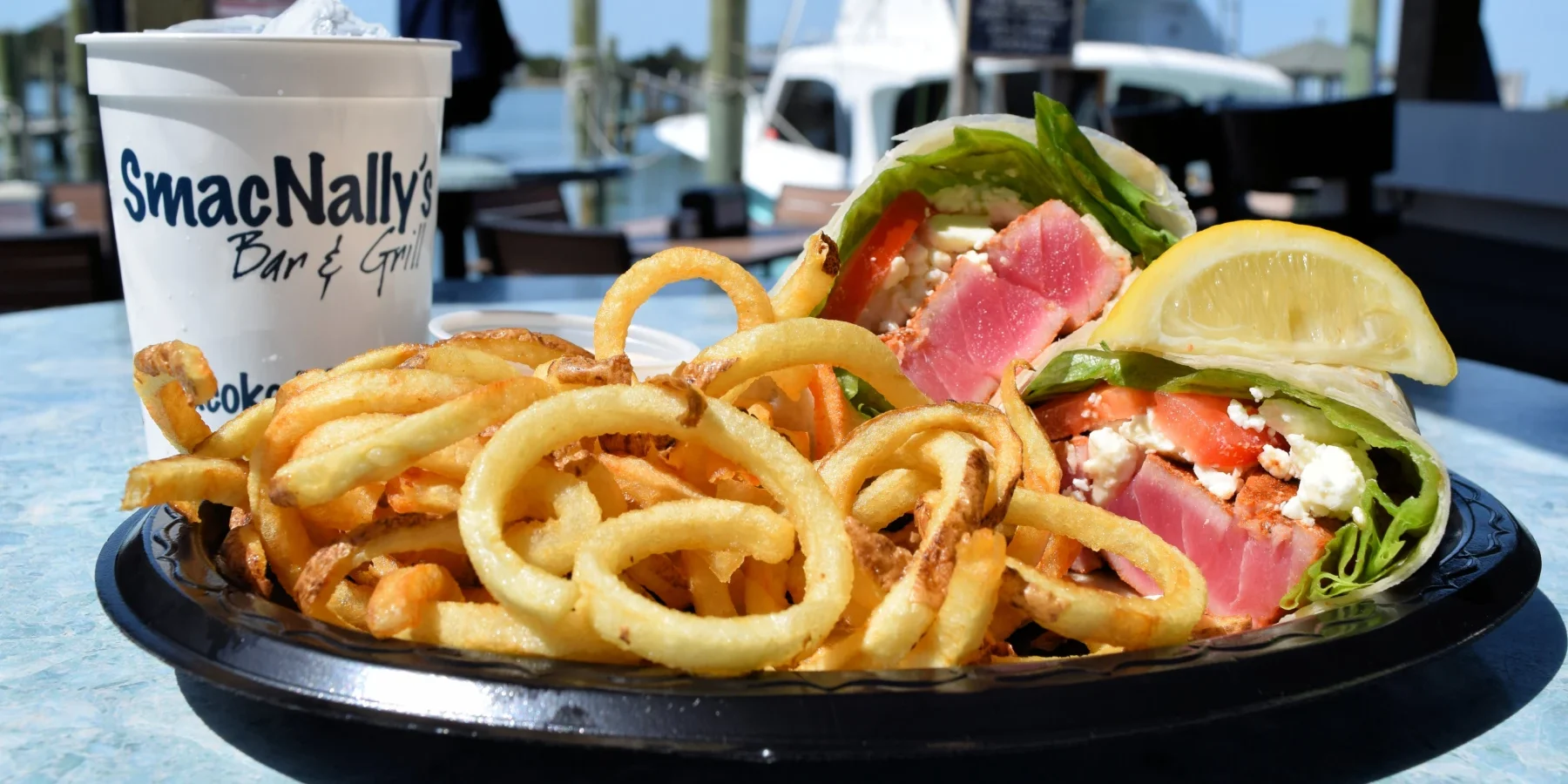Ahi Tuna Sandwich Wrap with Curly Fries at SmacNallys Waterfront Bar and Grill - Hero