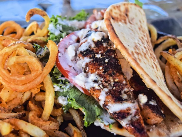 Blackened Chicken Pita with a Side of Curly Fries at SmacNallys Waterfront Bar and Grill - Hero